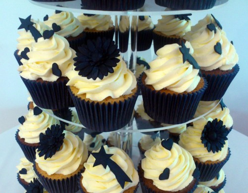 wedding cupcake tower with giant cupcake bride and groom topper