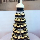 wedding cupcake tower with giant cupcake bride and groom topper