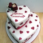 2 tier heart shaped engagement cake with ring in a box