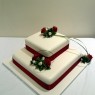 2 tier square stacked wedding cake with deep red rose sugar flower spray  thumbnail