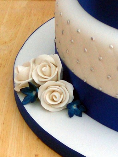 3 tier round stacked wedding cake sapphire blue and white sugar flowers