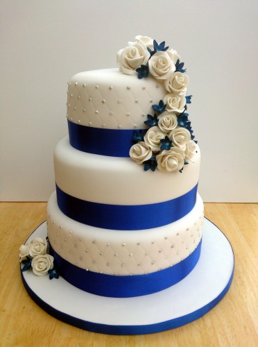 3 tier round stacked wedding cake sapphire blue and white sugar flowers