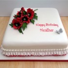 square birthday cake with a sparkling spray of sugar poppies