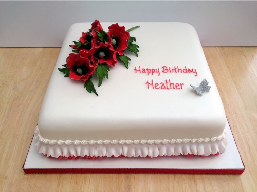 square birthday cake with a sparkling spray of sugar poppies