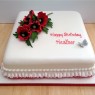 square birthday cake with a sparkling spray of sugar poppies thumbnail