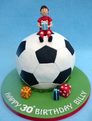 footballer sat on a football birthday cake