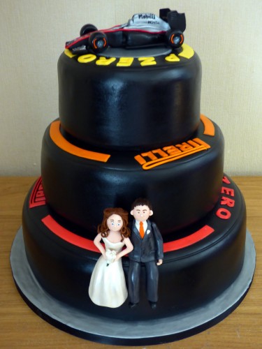 F1 pirelli tyre themed 3 tier wedding cake with bride and groom and F1Mclaren racing car