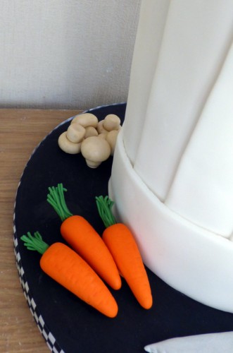 chefs hat birthday cake with fondant vegetables knife birthday cake