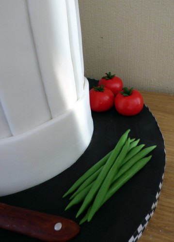 chefs hat birthday cake with fondant vegetables knife birthday cake