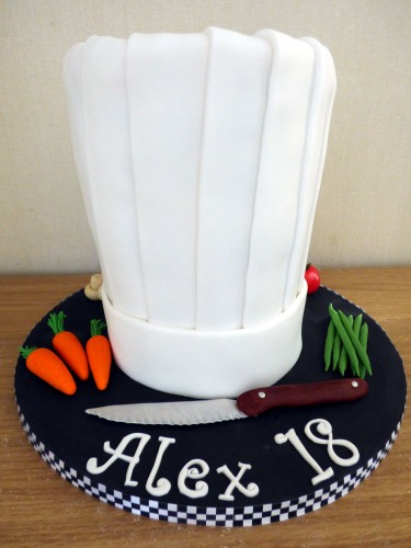 chefs hat birthday cake with fondant vegetables knife birthday cake