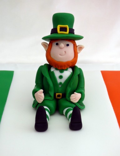 st patrick's day celebration cake with leprechaun topper