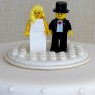 4-tier-ivory-wedding-cake-with-lego-figures-and-roses thumbnail