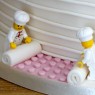 4-tier-ivory-wedding-cake-with-lego-figures-and-roses thumbnail