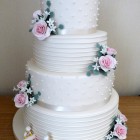 4-tier-ivory-wedding-cake-with-lego-figures-and-roses