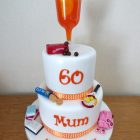 2-tier-multi-themed-birthday-cake-cocktail-maltesers-rich-tea-pamper-books-tennis